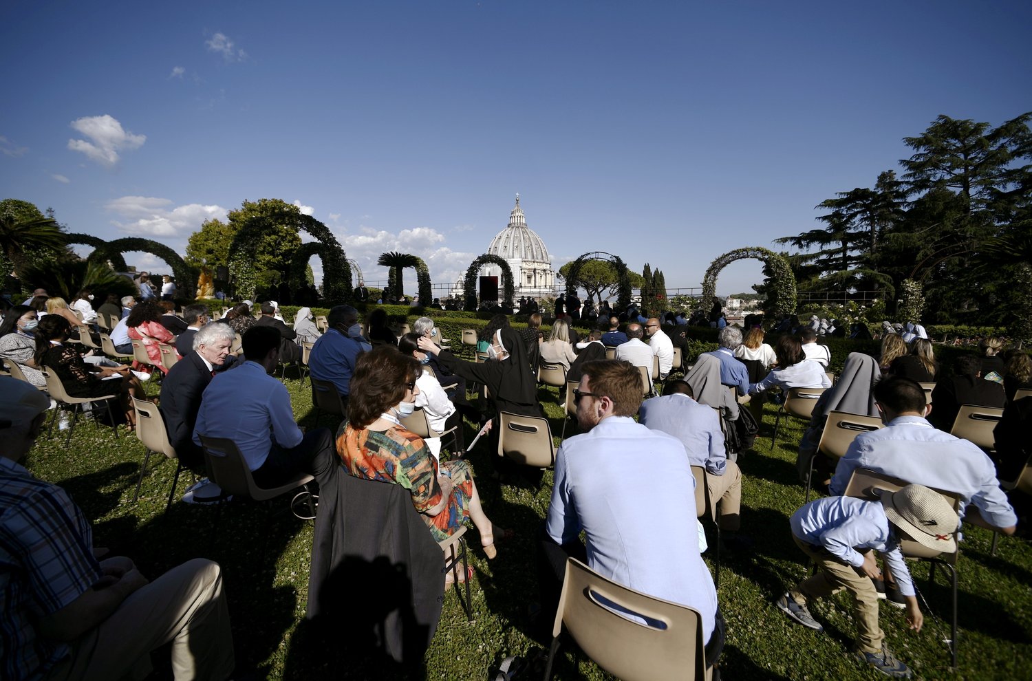 People wait for Pope Francis to arrive for an evening Marian prayer service in the Vatican Gardens May 31, 2021. The serviced finished a monthlong rosary marathon to pray for the end of the COVID-19 pandemic. (CNS photo/Filippo Monteforte, Reuters pool)
